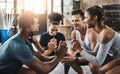 An exercise staple, the classic squat. a group of young people doing squats together during their workout in a gym. Royalty Free Stock Photo