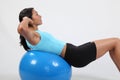 Exercise stomach crunches by athletic young woman