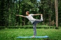 Exercise swallow. Fitness, man does yoga in tree pose in park Royalty Free Stock Photo