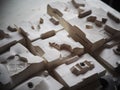 Exercise table with sample parts for ceramic production process education made by students in a demonstration factory workshop of