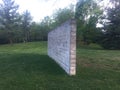 Exercise wall constructed of cinder blocks surrounded by grass in park