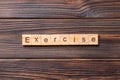 Exercise word written on wood block. exercise text on table, concept