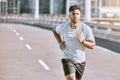 Exercise, workout and training with a healthy man training for sport, fitness and wellness outside in the city. Running Royalty Free Stock Photo