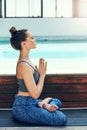 Exercise your mind by meditating. a beautiful young woman practicing yoga outside.