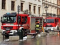 Exercises fire brigade in the old part of the city in the winter. Elimination of fire and natural disasters. Emergency response se Royalty Free Stock Photo