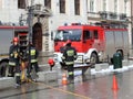 Exercises fire brigade in the old part of the city in the winter. Elimination of fire and natural disasters. Emergency response se Royalty Free Stock Photo