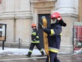 Exercises fire brigade in the old part of the city in the winter. Elimination of fire and natural disasters. Emergency response se Royalty Free Stock Photo