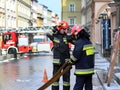 Exercises fire brigade in the old part of the city in the winter. Elimination of fire and natural disasters. Emergency response se Royalty Free Stock Photo