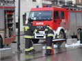 Exercises fire brigade in the old part of the city in the winter. Elimination of fire and natural disasters. Emergency response se Royalty Free Stock Photo