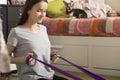 Exercises at home for stretching and strengthening muscles, the girl is engaged with an elastic band
