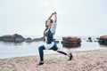 Exercises with sunrise. Side view of beautiful disabled athlete woman in sportswear with prosthetic leg standing in yoga Royalty Free Stock Photo