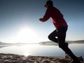 Exercising on the beach at sunset, sun at horizon Royalty Free Stock Photo