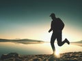 Exercising on the beach at sunset, sun at horizon Royalty Free Stock Photo