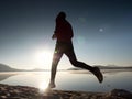 Exercising on the beach at sunset, sun at horizon Royalty Free Stock Photo