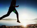 Exercising on the beach at sunset, sun at horizon Royalty Free Stock Photo