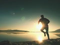 Exercising on the beach at sunset, sun at horizon Royalty Free Stock Photo