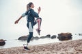 Exercising every morning. Side view of young sporty disabled woman with prosthetic leg is doing sport exercises on the Royalty Free Stock Photo