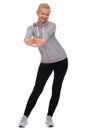 While exercising, the girl stands apart and stretches out both hands in front of her and leans her hips to the side Royalty Free Stock Photo