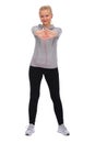 While exercising, the girl stands straddling and stretches out both hands in front of her. Front view Royalty Free Stock Photo
