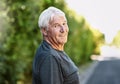 Exercising gives me a great sense of wellbeing. Portrait of a senior man out for a run.