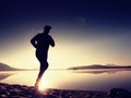 Exercising on the beach at sunset, sun at horizon Royalty Free Stock Photo