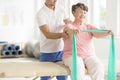 Exercising with an resistance band with a support of a physiotherapist Royalty Free Stock Photo
