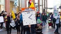 EXETER, DEVON, UK - February 08 2020: Extinction Rebellion demonstrator carries a sign Time Is Running Out 2020 Tipping Point