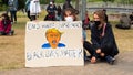 EXETER, DEVON, UK - June 06 2020: Two women hold a sign picturing Donald Trump with a pacifier at Black Lives Matter demonstration