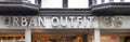 EXETER, UNITED KINGDOM - NOVEMBER 6 2019: Urban Outfitters shop front sign in Exeter city centre with a pigeon nesting in the firs