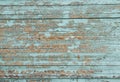 Exfoliated blue paint on the wall of wooden boards