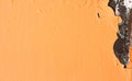 Exfoliated orange paint. Paint on metal surface. Close up
