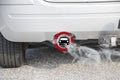 Exhaust from a car with the traffic sign for driving ban, in ger Royalty Free Stock Photo