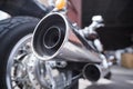 Exhaust chrome pipe of an old touring motorcycle in close-up