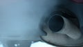 Exhaust coming out from tailpipe on a idling parked car