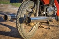 Exhaust pipe and rear wheel of a rare motorcycle, red bike Royalty Free Stock Photo