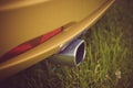 Exhaust pipe in a yellow sports car. Royalty Free Stock Photo