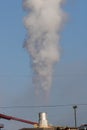 Exhaust stack blowing steam from factory Royalty Free Stock Photo