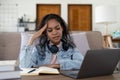 Exhausted african-american businesswoman having headache in office. Bored young african girl tired of learning sit at Royalty Free Stock Photo