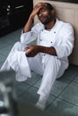 exhausted african american chef sitting on floor