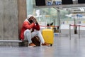 Exhausted African man on a long night connection at airport, waiting for a plane sitting in terminal Royalty Free Stock Photo