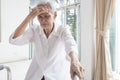 Exhausted asian senior woman is touching her head with hand,symptoms of vertigo illness,loss balance dizzy,meniereÃ¢â¬â¢s disease,