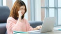 Exhausted asian woman take a break while working with laptop computer at home office, Tried asia female  take a nap from overwork Royalty Free Stock Photo