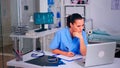 Exhausted assistant staring at laptop screen, wrinting on clipboard Royalty Free Stock Photo