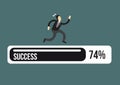 Exhausted business executive in suit running on a success progress bar Royalty Free Stock Photo