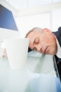 Exhausted businessman asleep at work