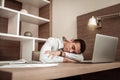 Busy exhausted businessman falling asleep on his working table Royalty Free Stock Photo