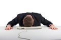 Exhausted businessman falling asleep at his office desk isolated on white Royalty Free Stock Photo