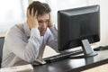 Exhausted Businessman Looking At Computer Monitor