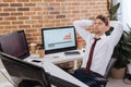 young businessman sitting near computers, smartphone Royalty Free Stock Photo