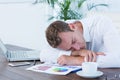 Exhausted businessman sleeping on the desk Royalty Free Stock Photo